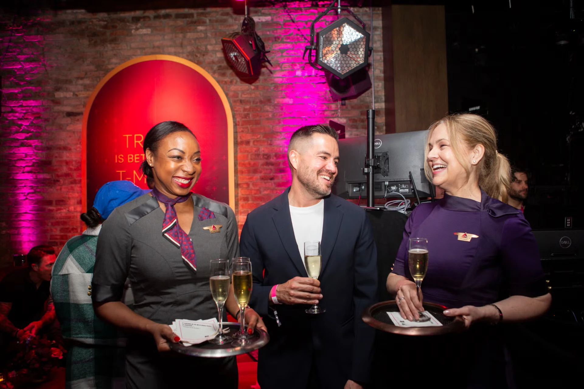 Delta Air Lines flight attendants deliver an elevated hospitality experience, welcoming T-Mobile members and serving complimentary cocktails at the Magenta Sky Lounge activation at Laissez Faire on Tuesday, June 16, 2026 in New York City. (Calla Kessler/AP Content Services for T-Mobile)